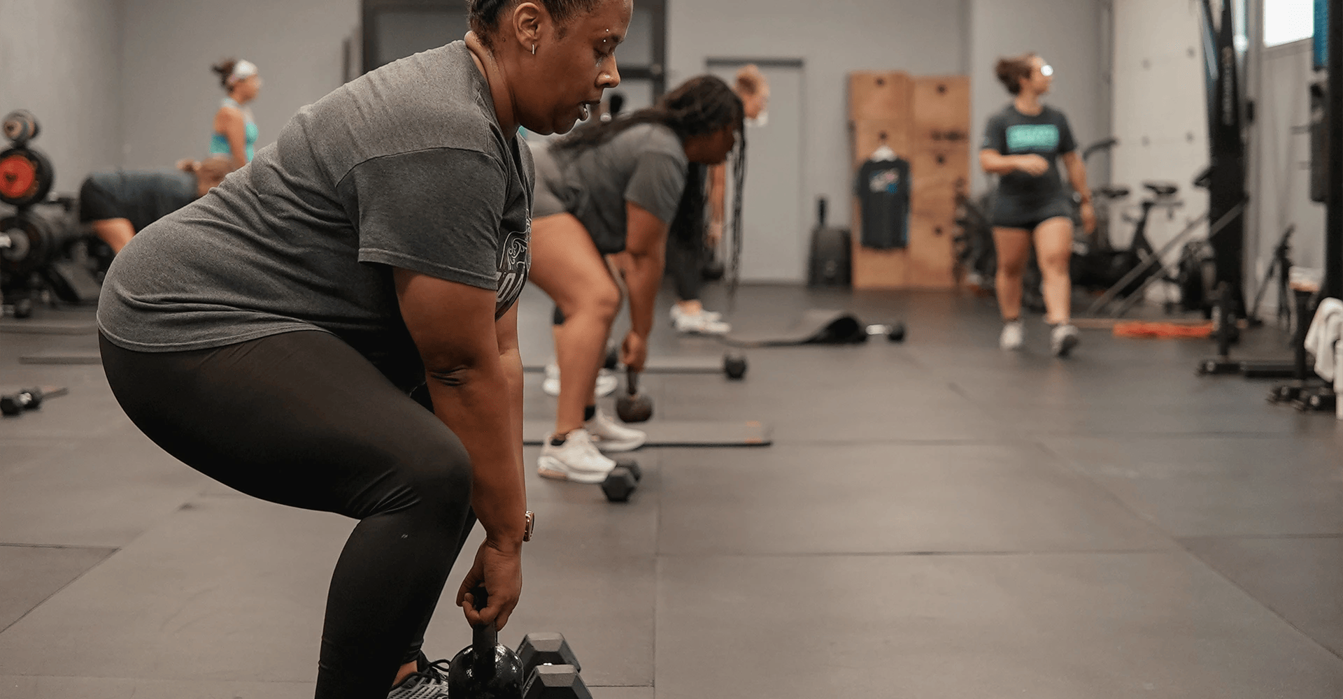 women training with weights at MetroEast Health and Fitness